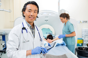 Image showing Radiologist Using Digital Tablet During CT Scan