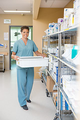 Image showing Nurse Carrying Container In Hospital Storage Room