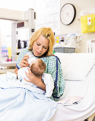 Image showing Mother Feeding Milk To Baby Girl In Hospital Bed