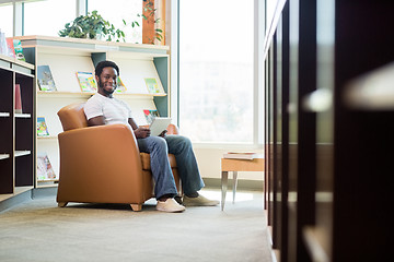 Image showing Student Using Digital Tablet In Bookstore