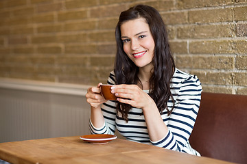 Image showing Woman in Coffee Shop Holding Cup