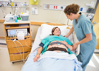 Image showing Nurse Communicating With Pregnant Patient Lying In Hospital Bed
