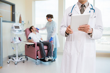 Image showing Doctor Holding Digital Tablet In Chemo Room
