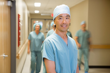 Image showing Doctor With Medical Team Walking In Hospital Corridor