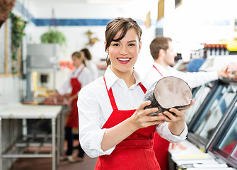 Image showing Happy Female Butcher Holding Large Ham