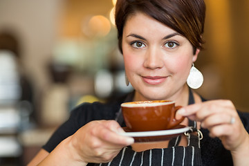 Image showing Beautiful Barista Holding Coffee Cup