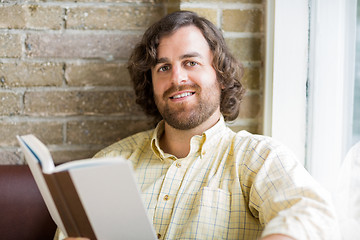 Image showing Man With Book In Coffeeshop