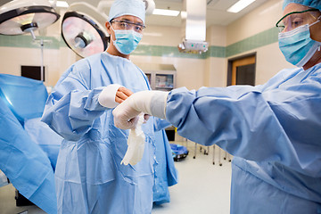 Image showing Nurse Assisting Doctor with Sterile Glove