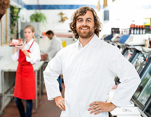 Image showing Portrait Of Confident Butcher Standing At Store