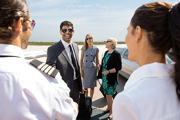 Image showing Business People Greeting Pilot And Airhostess At Airport Termina