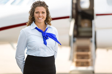 Image showing Beautiful Stewardess With Private Jet In Background