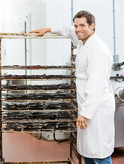 Image showing Worker Standing By Rack Of Beef Jerky At Shop