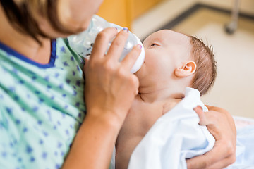 Image showing Mother Feeding Milk To Newborn Baby Girl In Hospital