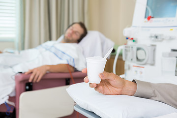 Image showing Cancer Patient Holding Glass Of Crushed Ice