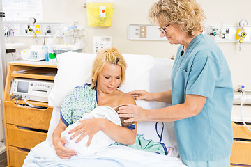 Image showing Nurse Helping Woman In Breast Feeding Baby In Hospital