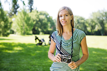 Image showing Happy Woman With Digital Camera In Park