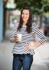 Image showing Woman Holding Coffee Cup Outdoors