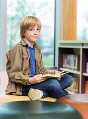 Image showing Happy Boy Reading Book In Library