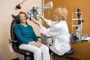 Image showing Eye Specialist Adjusting Phoropter For Woman