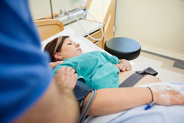 Image showing Man's Hand Consoling Pregnant Wife Lying On Hospital Bed