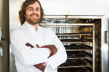 Image showing Butcher Standing Arms Crossed By Oven