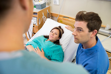 Image showing Pregnant Woman And Husband Looking At Nurse In Hospital