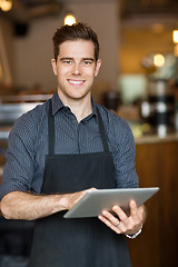 Image showing Happy Owner Holding Digital Tablet In Cafe