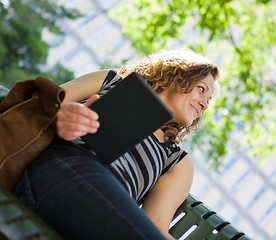 Image showing University Student Holding Digital Tablet On Bench