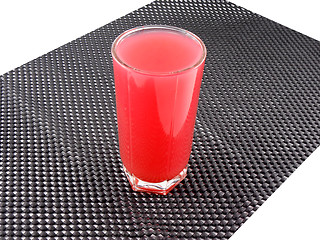Image showing fresh cherry juice in a glass on black background