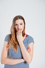 Image showing Attractive woman covering mouth with hand