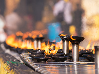 Image showing Burning oil lamps at the Shwedagon Pagoda in Yangon