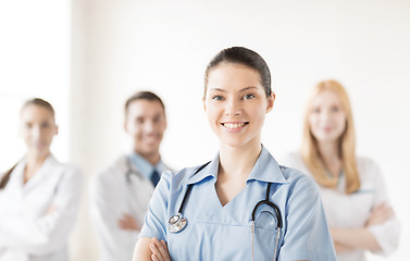 Image showing female doctor in front of medical group