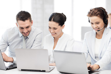 Image showing group of people working with laptops in office