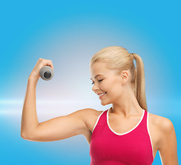 Image showing young sporty woman with light dumbbell