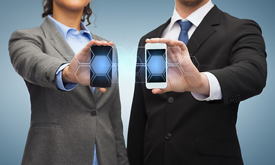 Image showing businessman and businesswoman with smartphones