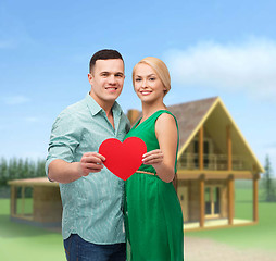 Image showing smiling couple holding big red heart