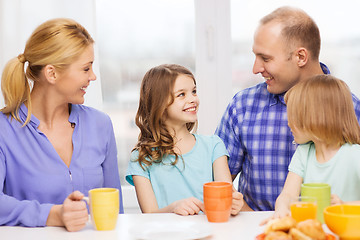 Image showing happy family with two kids with having breakfast