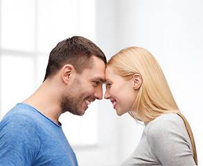 Image showing smiling couple looking at each other