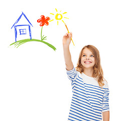 Image showing cute little girl drawing house with brush