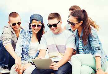 Image showing group of teenagers looking at tablet pc