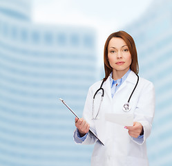 Image showing calm female doctor with clipboard