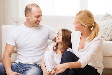 Image showing parents and little girl sitting on floor at home