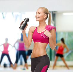 Image showing sporty woman drinking water from sportsman bottle