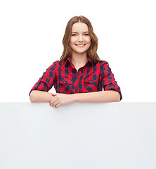 Image showing smiling young teenage girl with white blank board