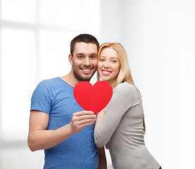 Image showing smiling couple holding big red heart