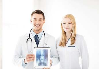 Image showing two doctors showing x-ray on tablet pc