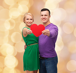 Image showing smiling couple holding big red heart