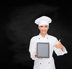 Image showing smiling female chef with tablet pc blank screen