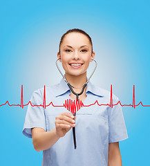 Image showing smiling female doctor or nurse with stethoscope