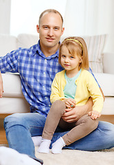 Image showing smiling father and daughter sitting on the floor